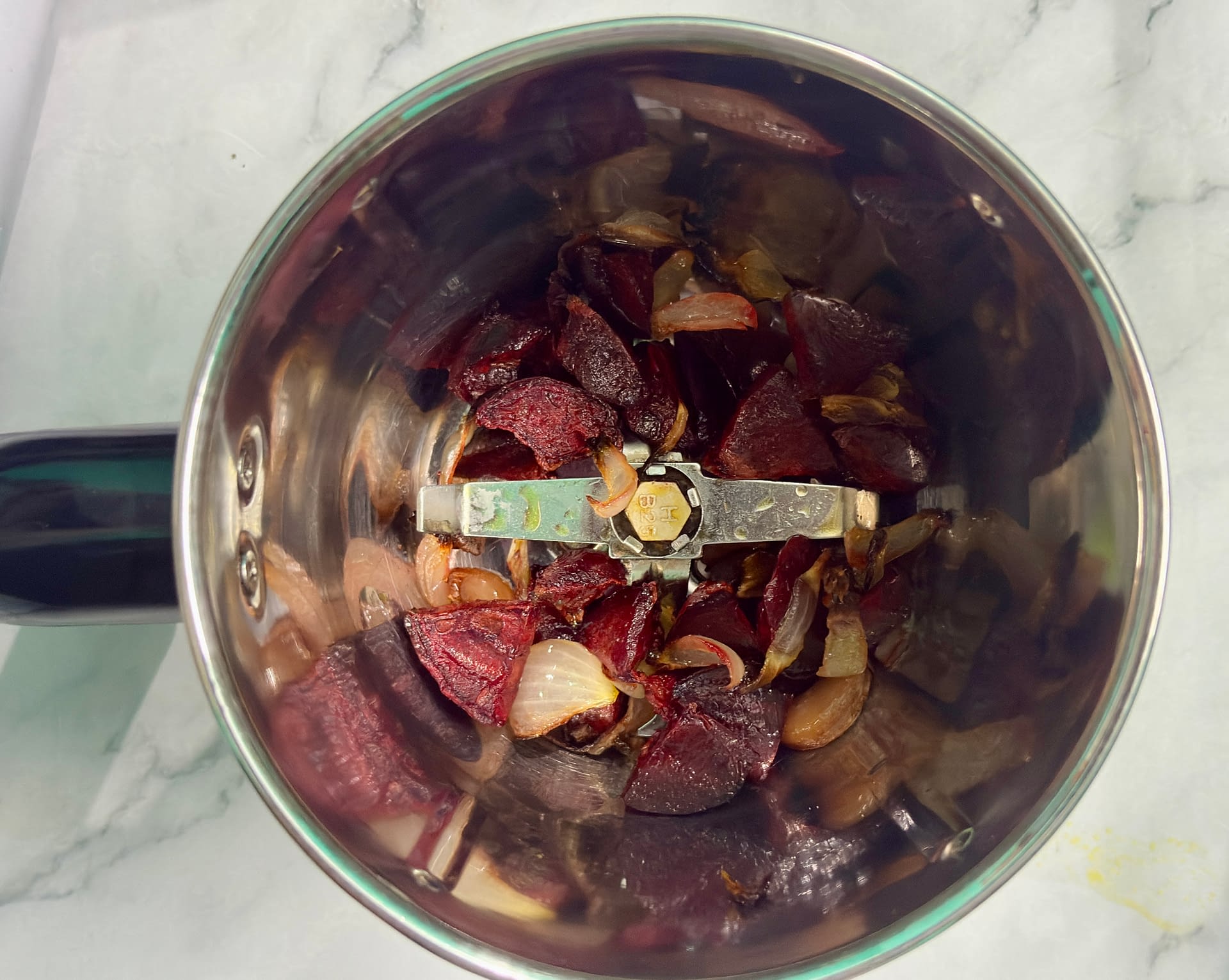 Roasted ingredients in mixer to make simple beetroot pasta recipe.
